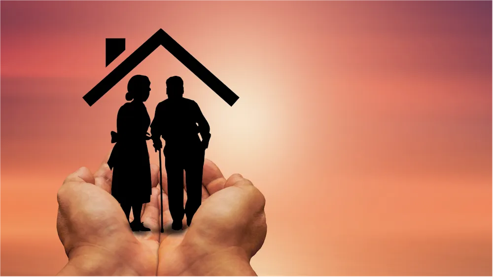 Ihre liebevolle Pflege im Alten Land Ein paar Hände mit der Silhouette eines Rentnerpaares und Hausdach